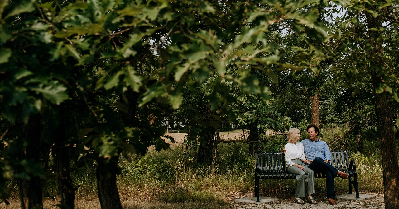Couple sitting on park bench